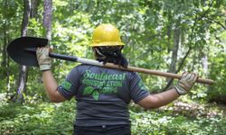 Southeast Conservation Corps crew member with shovel on the trail