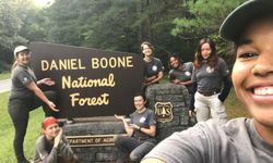 Womens crew takes a selfie in front of Daniel Boone National Forest