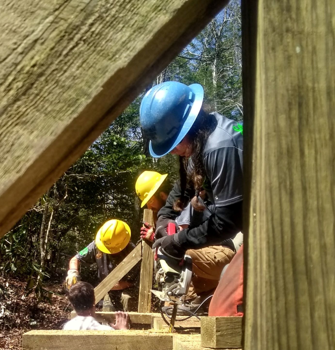 Crew-947-members-drilling-the-finishing-touches-on-a-newly-constructed-bridge.jpg#asset:483