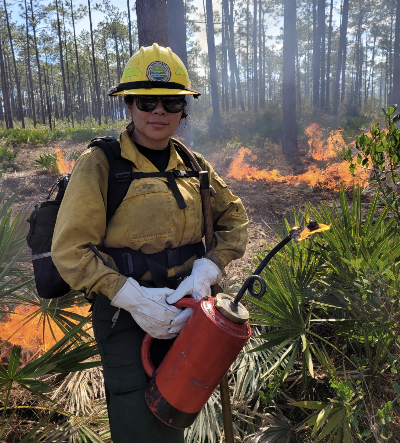VFC Crew member poses with blowtorch with fire in the background